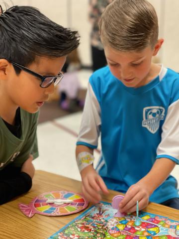 2nd grade students playing a fun board game