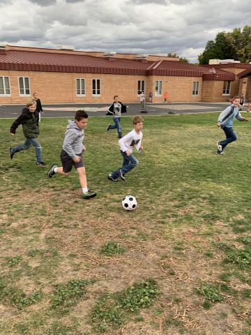 Putting donated soccer ball into action.