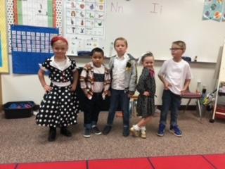 Mrs. Toelupe's kinder kids posing in their poodle skirts and leather jackets