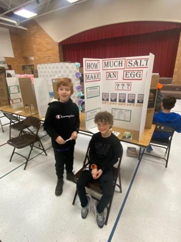 Trey and Felix in front of their projects 
