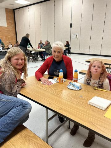 Grandparents eating with their grandchildren