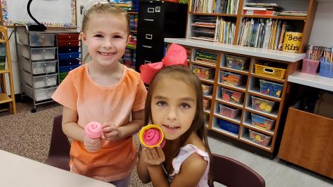 Showing off Playdoh creations in Mrs. Barney's first grade class