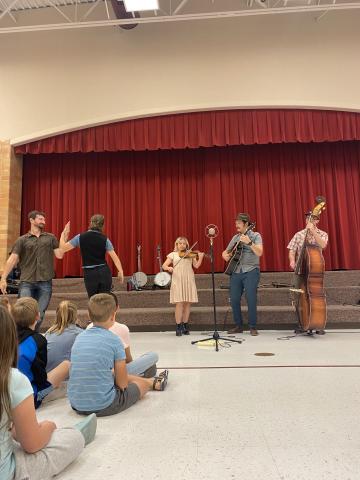 Fiddle Tunes String Band teaching us about the dancing that usually accompanies bluegrass music