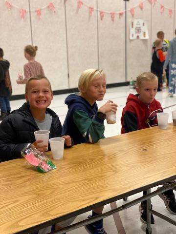 3rd grade boys enjoying chocolate milk and donut holes