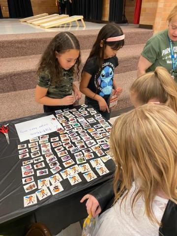 3rd graders looking at different temporary tattoo options