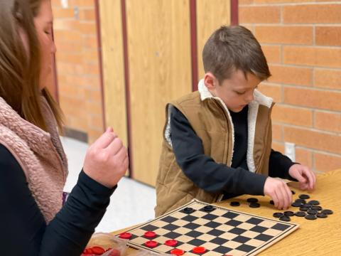 2nd grade student playing checkers