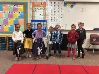 Mrs. Toelupe's kinder kids posing in their poodle skirts and leather jackets